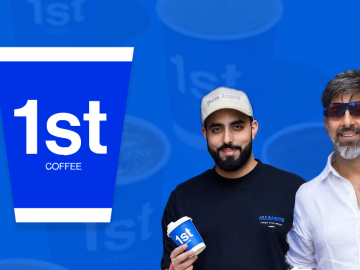 Two men holding 1st Coffee cups.